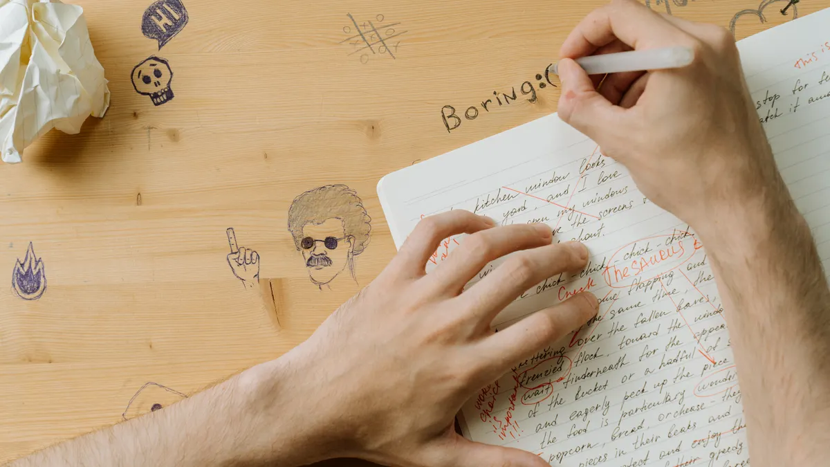 AI Blog Outline Generator: How to Build Better Outlines — Person Writing on Wooden Table
