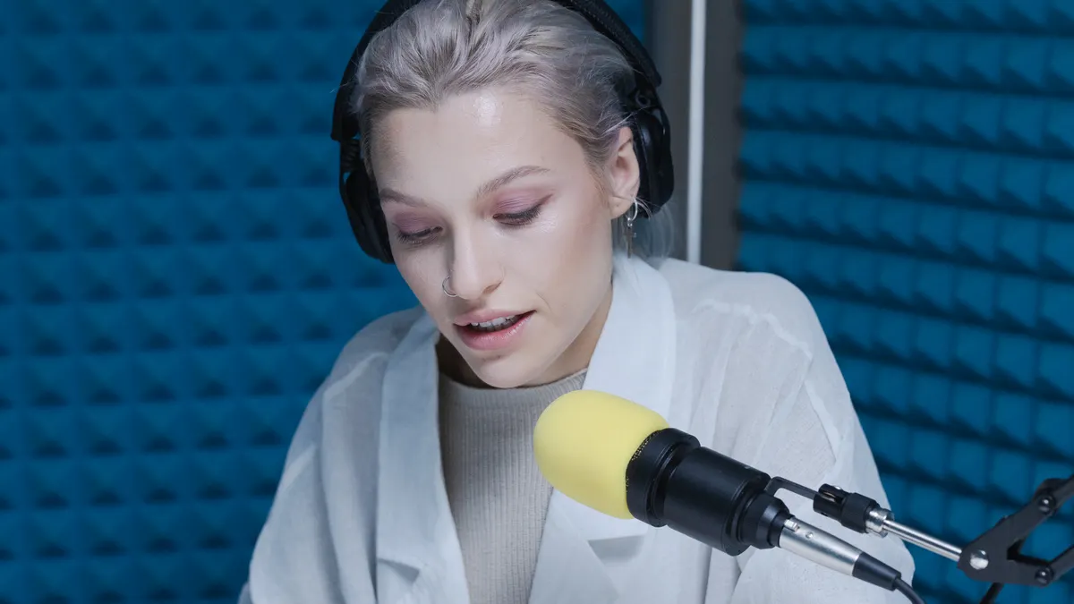 How to Edit AI-Generated Blog Posts for Voice and Accuracy — A Woman in White Blazer with a Black Headphones Writing on 