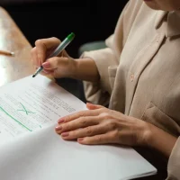 person reviewing and marking up a document with edits