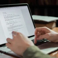 Person editing a text draft on a laptop