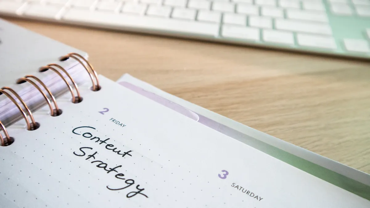 Planner notebook with handwritten content strategy beside a keyboard